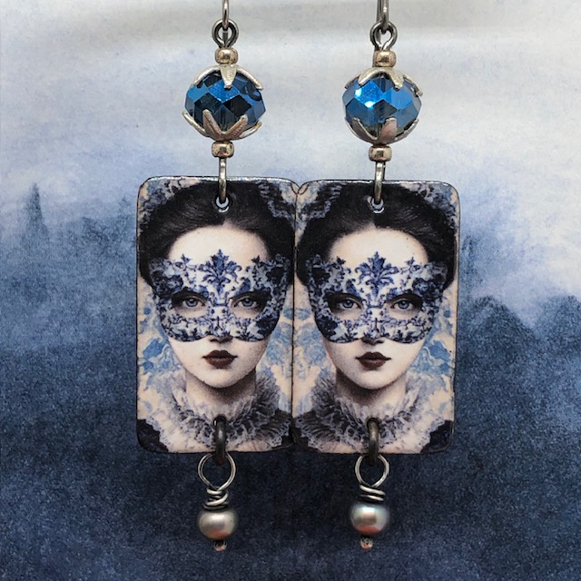 Grandes boucles d’oreilles bal masqué composées de pendentifs en cuivre émaillé bleus avec une femme portant un masque en dentelle. Bijoux uniques.