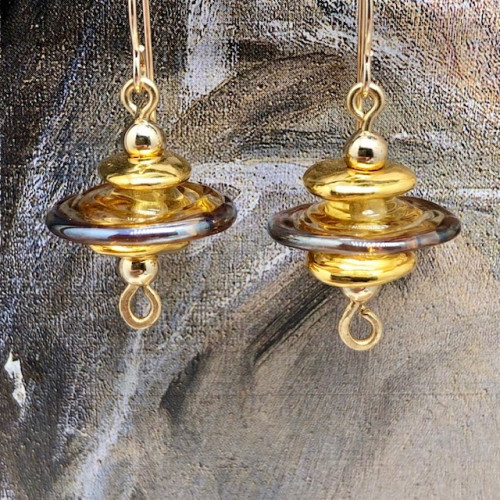 Boucles d'oreilles asymétriques composées de perles disques en verre filé à la flamme et de perles en céramique. Bijoux uniques de créateur.