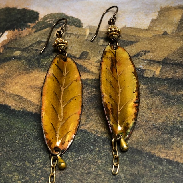 Longues boucles d'oreilles bohèmes composées de pendentifs en cuivre émaillé en forme de feuilles et de perles en vermeil Thaï Karen. Pièces uniques.