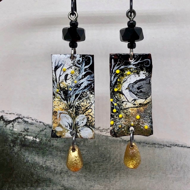 Boucles d’oreilles asymétriques et poétiques composées de pendentifs en cuivre émaillé représentant des oiseaux et une fleur. Bijoux uniques de créateur.
