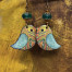 Boucles d’oreilles bohèmes composées de pendentifs en cuivre émaillé représentant un oiseau aux couleurs bigarrées. Bijoux uniques.