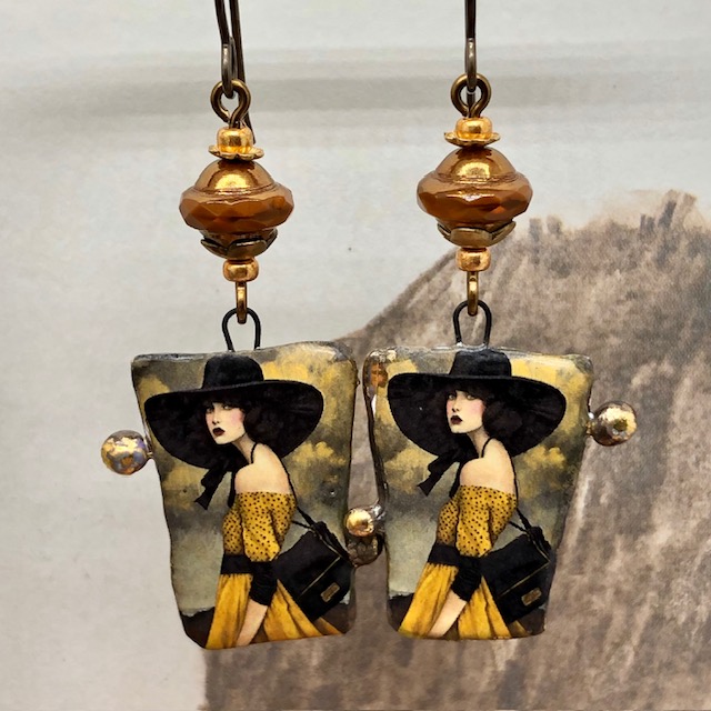 Boucles d’oreilles asymétriques composées de pendentifs en céramique avec le portrait d'une femme portant un chapeau noir. Bijoux uniques.