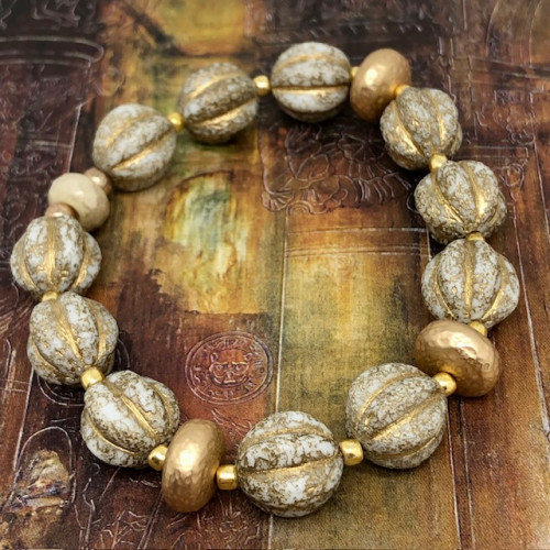 Bracelet élastique bohème chic composé de perles melon en verre de Bohême beige doré et de perles en laiton doré. Bracelet stretch de créateur.