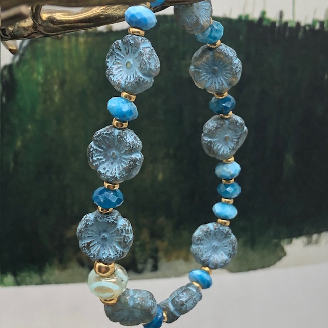 Bracelet élastique asymétrique, composé de perles en apatite et de perles en verre de Bohême bleu ciel en forme de fleur. Bracelet stretch de créateur.
